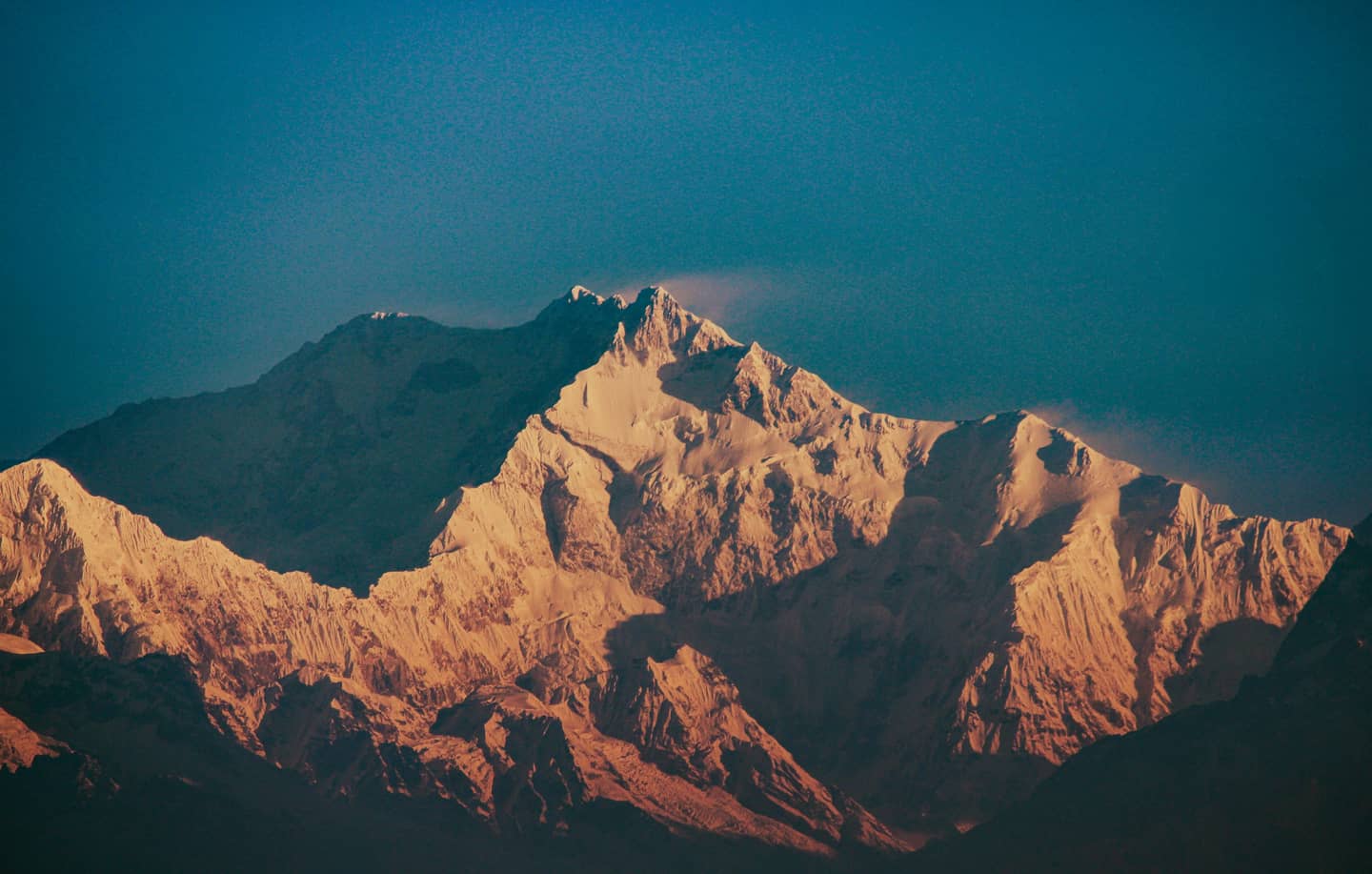 First light turning the peaks of Kangchenjunga gold — the kind of morning a group trip is for