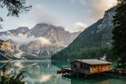 A lakeside cabin in morning mist